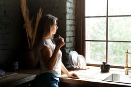side-view-woman-looking-out-window